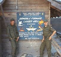 Men in uniform standing in front of a sign

Description automatically generated