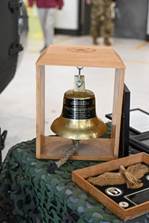 A bell in a wooden frame

Description automatically generated