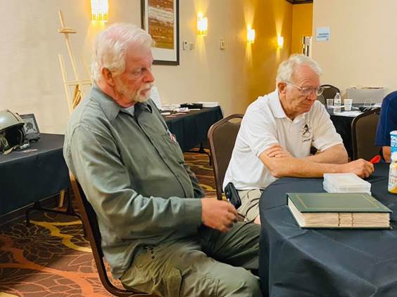 A couple of men sitting at a table

Description automatically generated with low confidence