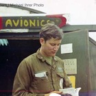 A person in uniform reading a book
Description automatically generated